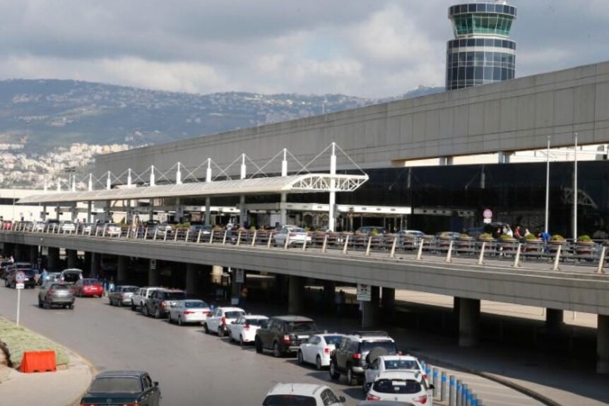 A general view shows Beirut international airport with cars lined up in a drop zone in Lebanon and mountains behind