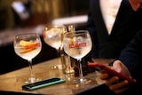 Close up of three gin drinks on a table in a London pub