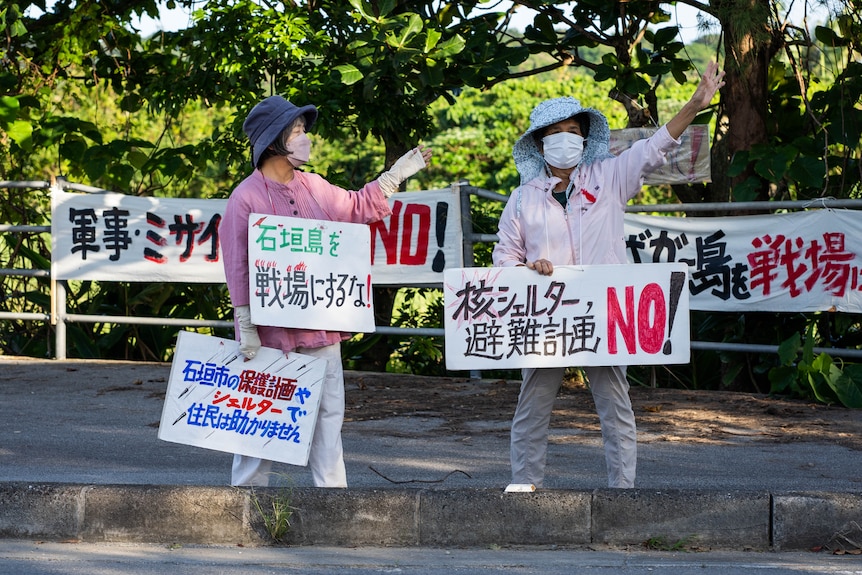 Women holding signs.