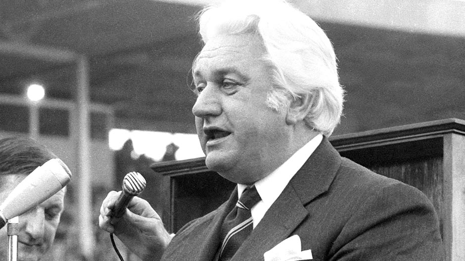 Sir John Kerr speaks in front of a microphone at the 1974 NSWRL Grand Final at the Sydney Cricket Ground.