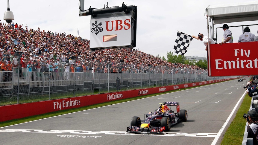 Daniel Ricciardo takes the chequered flag to win the Canadian F1 Grand Prix.