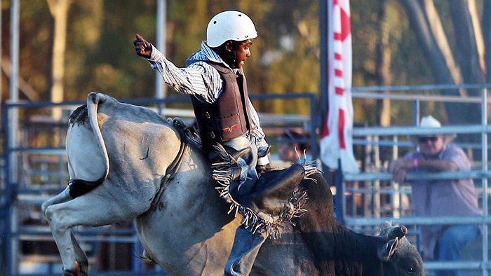 WA teen Sally Malay rides a bull at a rodeo
