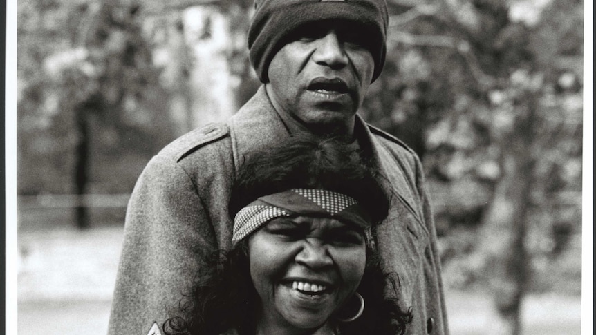 A black and white photo of Archie Roach and Ruby Hunter smiling together.