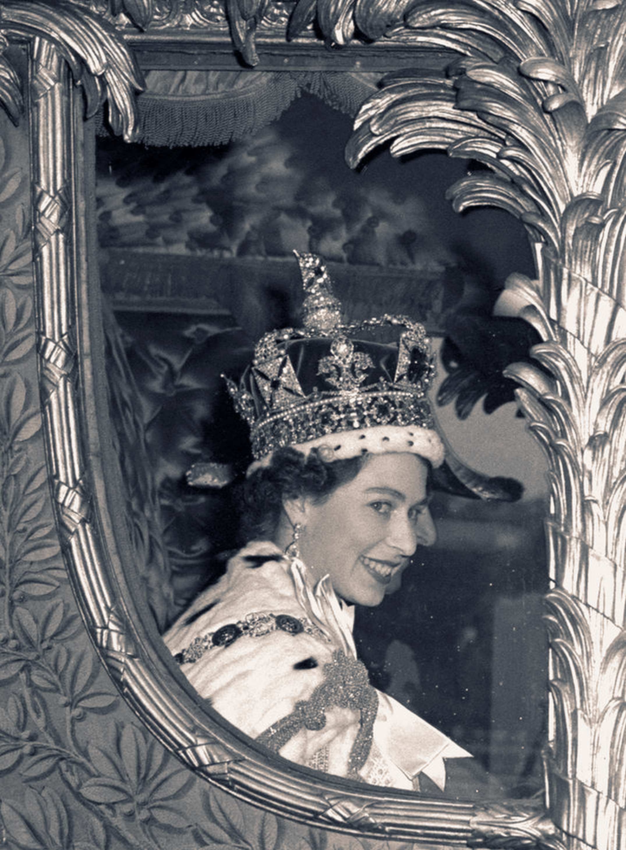 Queen Elizabeth II smiles through the window of a coach after her coronation in 1953.