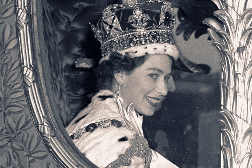 Queen Elizabeth II smiles through the window of a coach after her coronation in 1953.