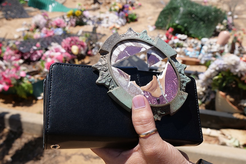 The smashed photo frame from a grave.