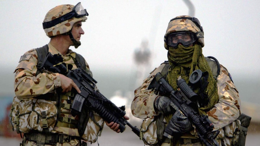 Australian soldiers stand guard in the port town of Umm Qasr