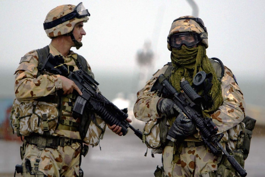 Australian soldiers stand guard in the port town of Umm Qasr