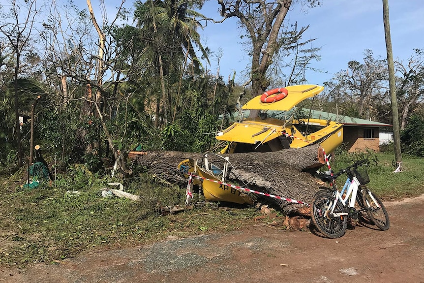80-year-old Dean Springbett's uninsured yellow boat is worse for wear after Cyclone Debbie