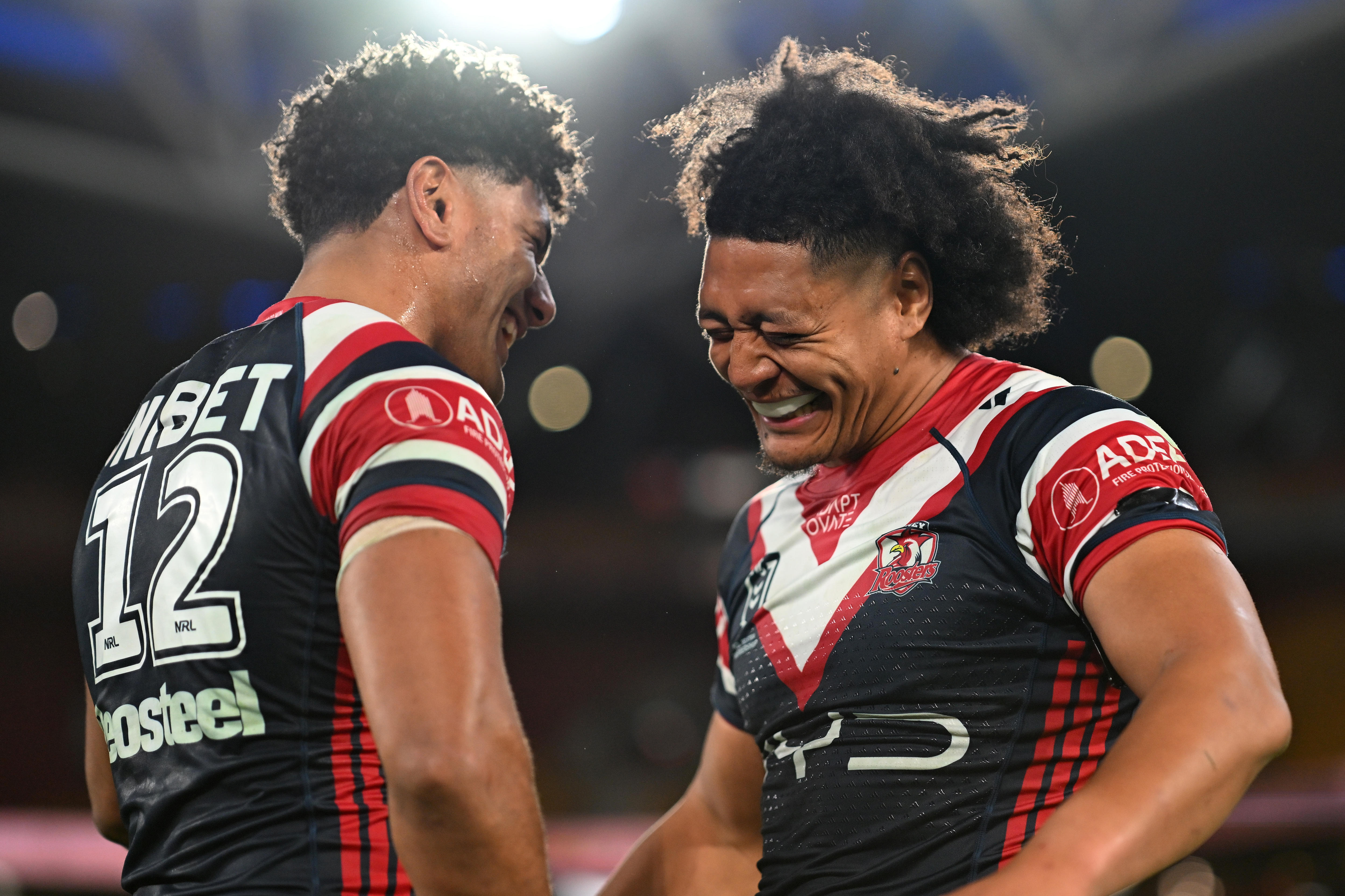 Two men celebrate after a rugby league match 