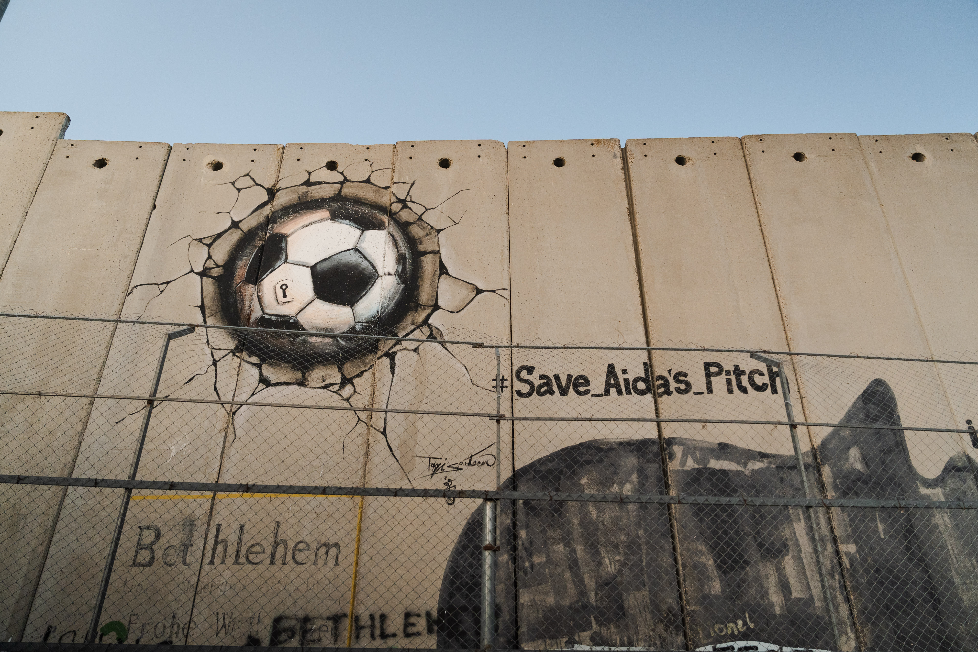 La campaña para salvar la cancha de fútbol quedó pintada con graffiti en una pared.