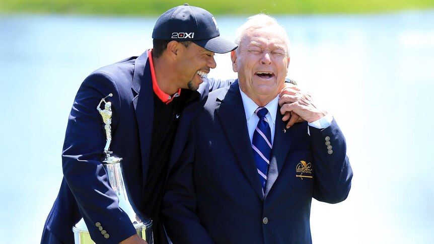 Old friends ... Tiger Woods (L) shares a laugh with the legendary Arnold Palmer
