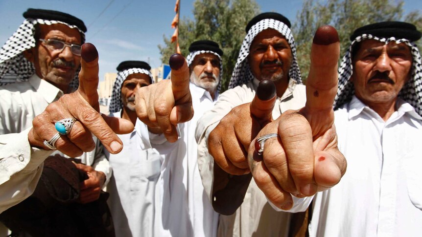 Iraqis voters showing ink-stained fingers