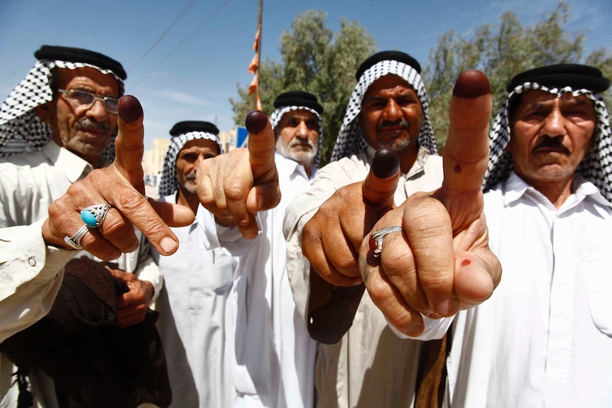 Iraqis voters showing ink-stained fingers