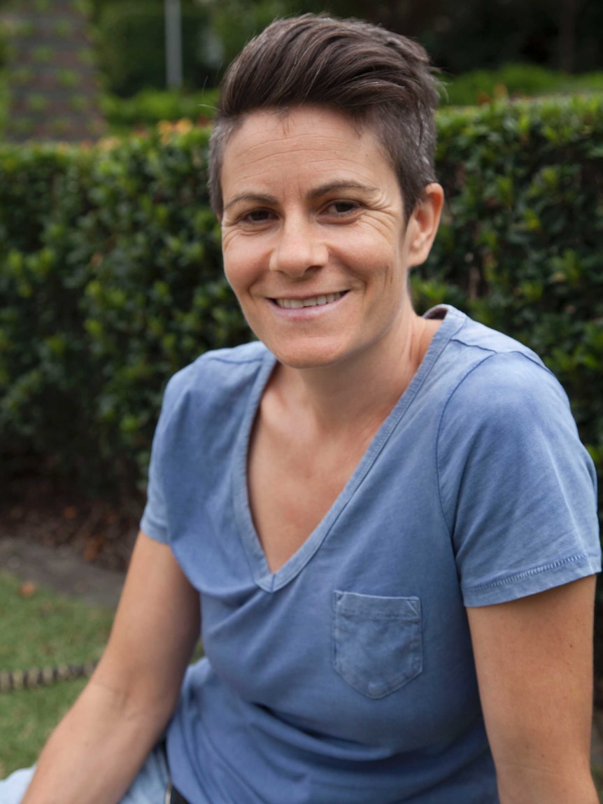 Woman sits in South Bank parklands in Brisbane.