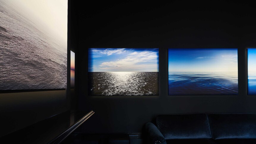 Images of the ocean and blue sky in a room at the exhibition