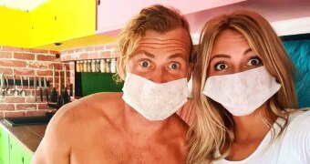 Chris Beer and Mietta Feery wearing face masks in their van in Mexico.