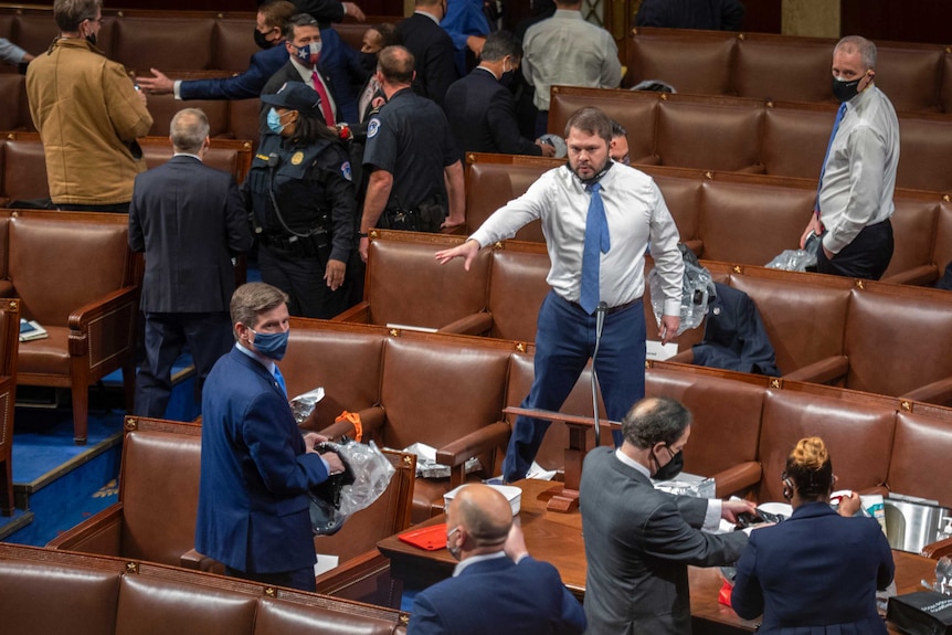 Democrat Congressman Ruben Gallego instructs people how to put on their gas masks when the Capitol building was under siege.