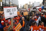 Workers rally in the Brooklyn borough of New York to demand higher pay