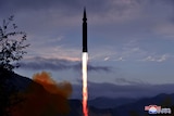 A hypersonic missile blasts off from land.