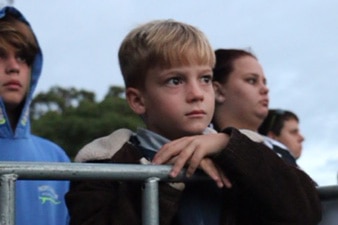 A young boy leaning on railing at the dawn service in Perth.