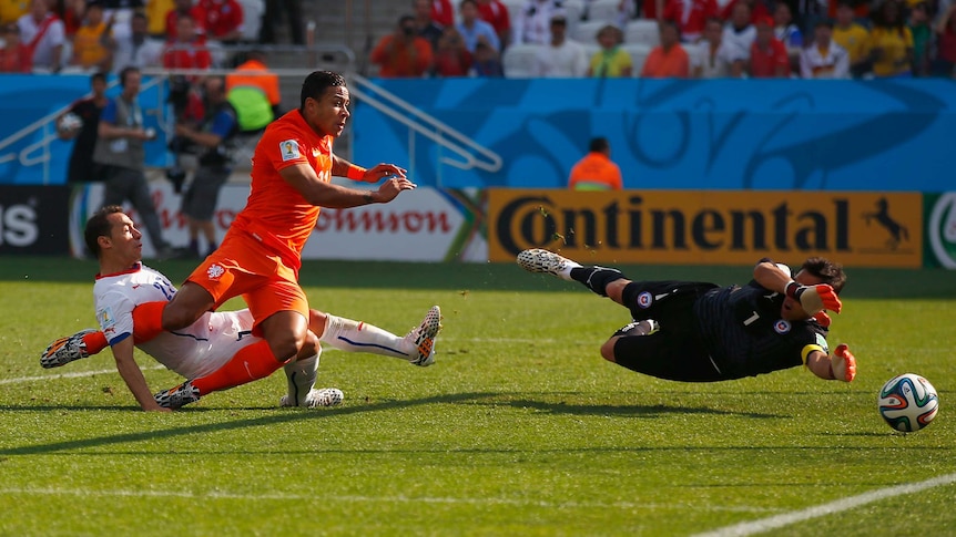 The Netherlands' Memphis Depay scores against Chile in Sao Paulo on June 23, 2014.