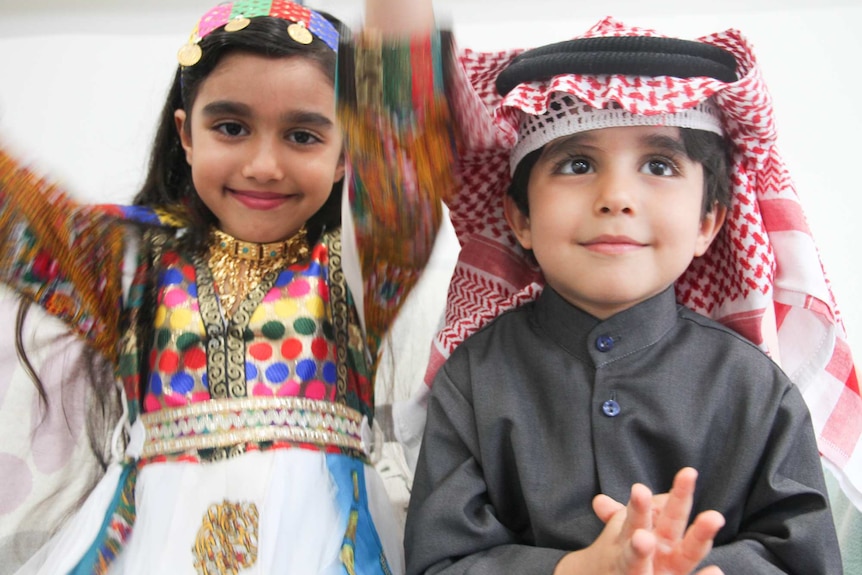 Two young children wearing the colourful traditional dress of Saudi Arabia