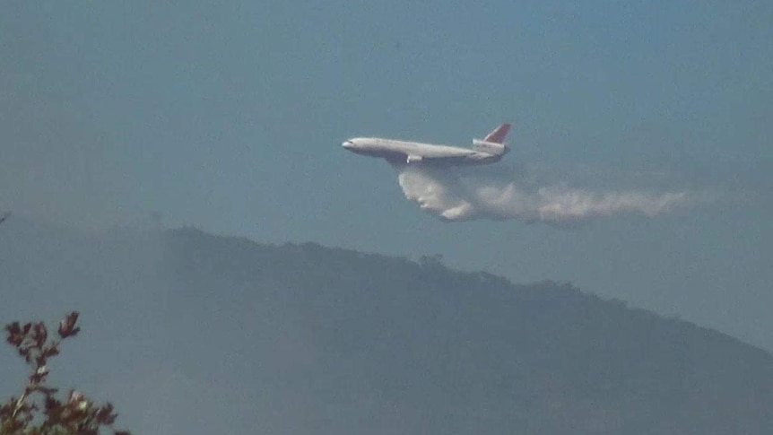 A plane drops water from the sky