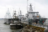HMS Visby and two minesweepers lie moored at the jetty at Berga marine base outside Stockholm October 22, 2014.