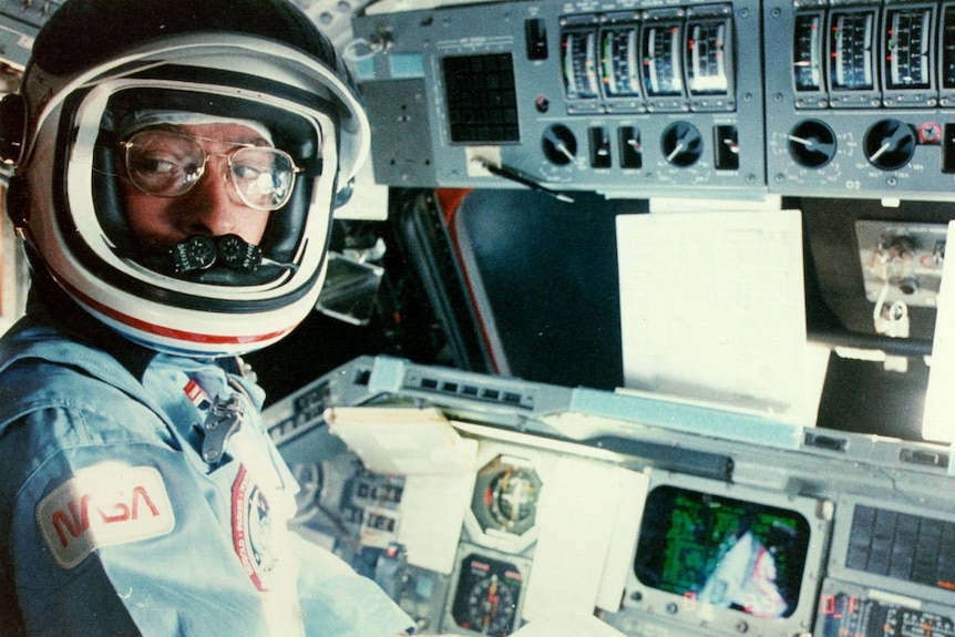 John Young at the STS-9 commander's station.
