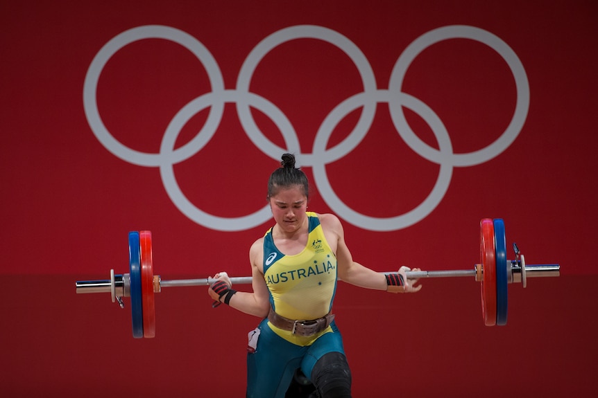 Kiana Elliott lifts weights at the Tokyo Olympic Games.