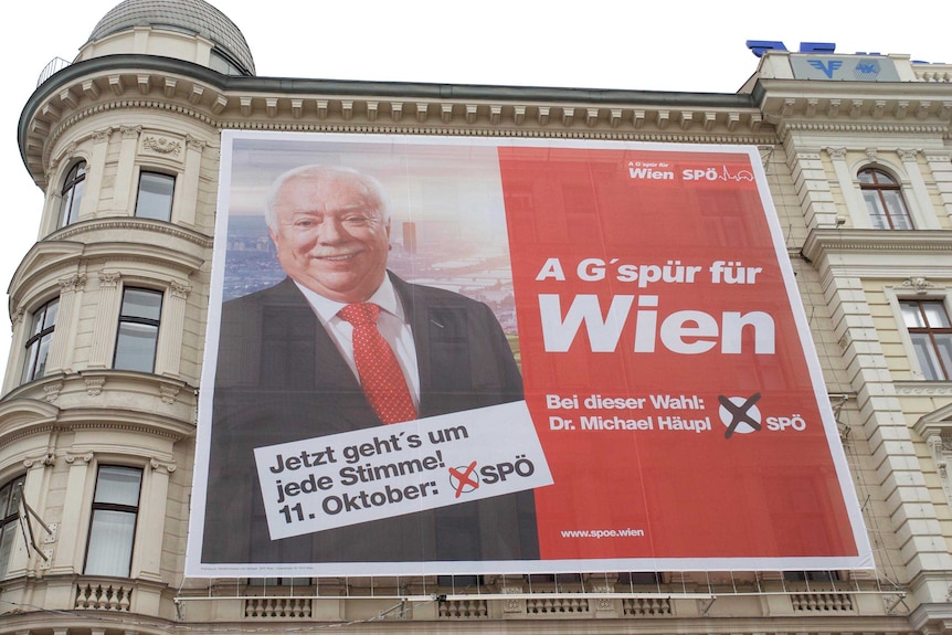 A campaign poster showing Dr Michael Häupl sits on the wall of the headquarters of Austria's Social Democrats.
