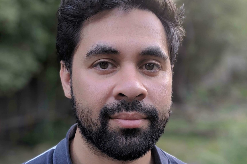 A head and shoulders image of a man with a beard.