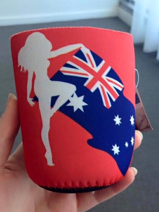 A stubby holder depicting a silhouetted naked woman.