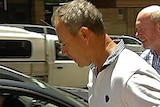 Andrew Crook led to police car