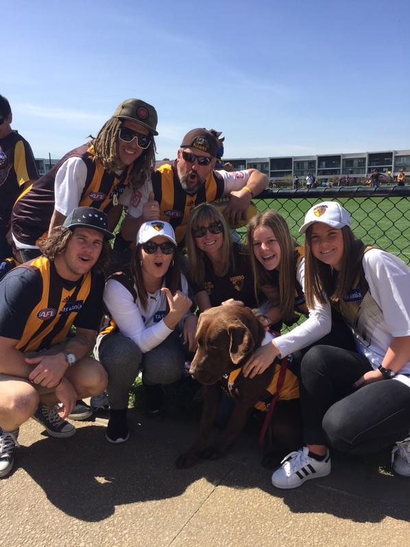 Hawks fan Buddy the dog and his family at the final training session