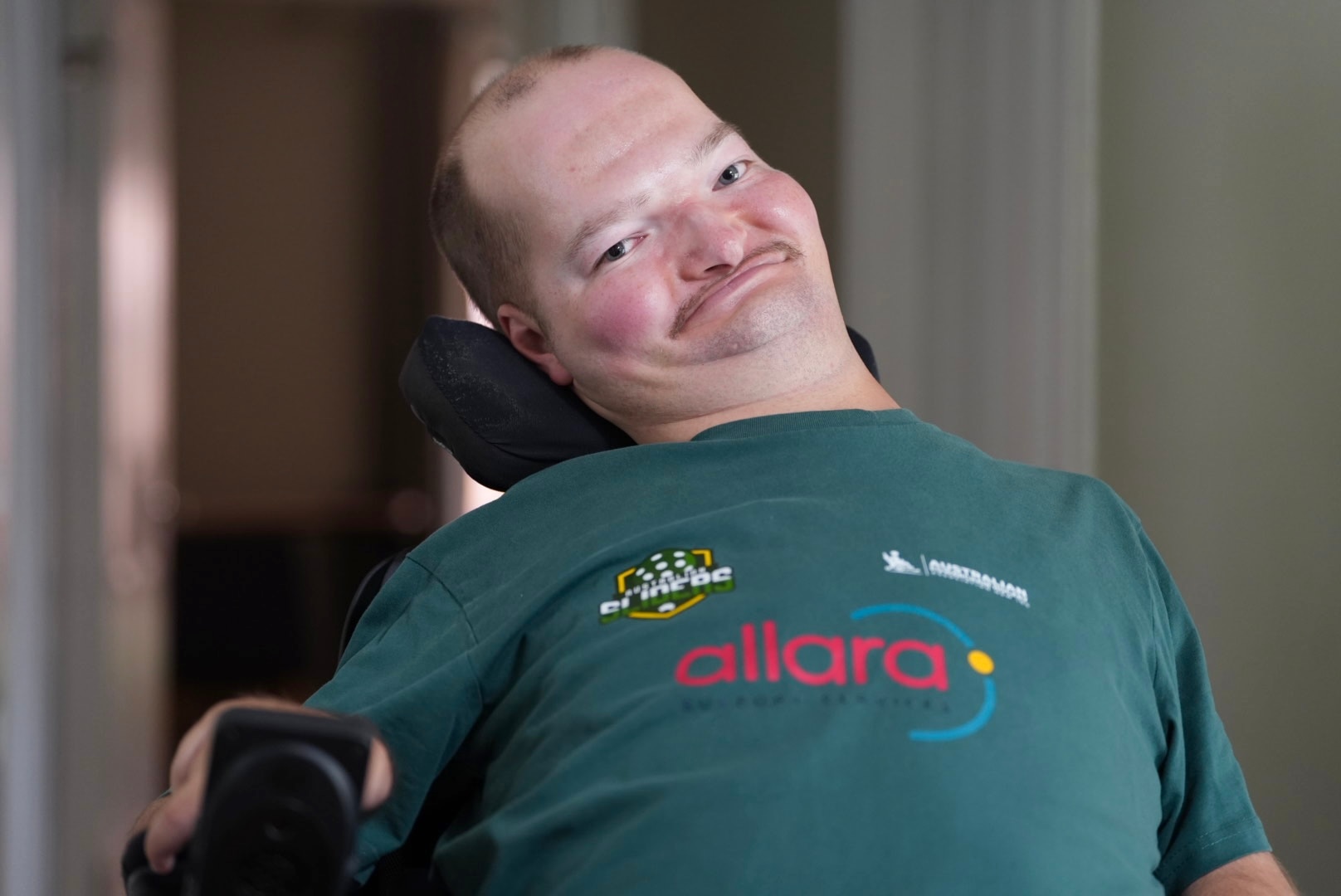 Kieran Watts in a powerchair and green top