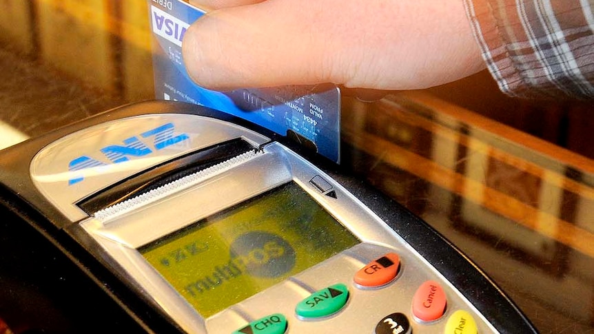 A debit card being swiped through an EFTPOS machine.