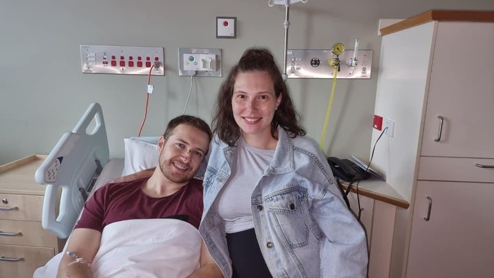 Constable Randall Kirk in hospital with his pregnant partner.