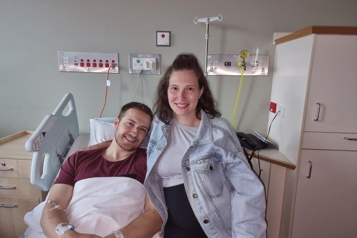 Constable Randall Kirk in hospital with his pregnant partner.