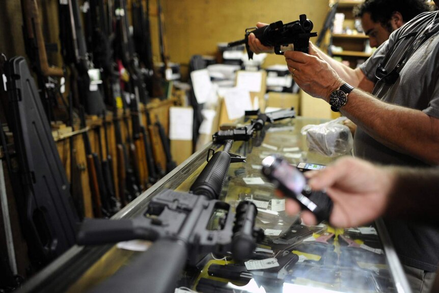Customers look at guns in a Florida shop