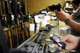 Customers look at guns in a Florida shop