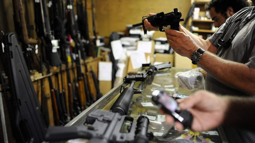 Customers look at guns in US