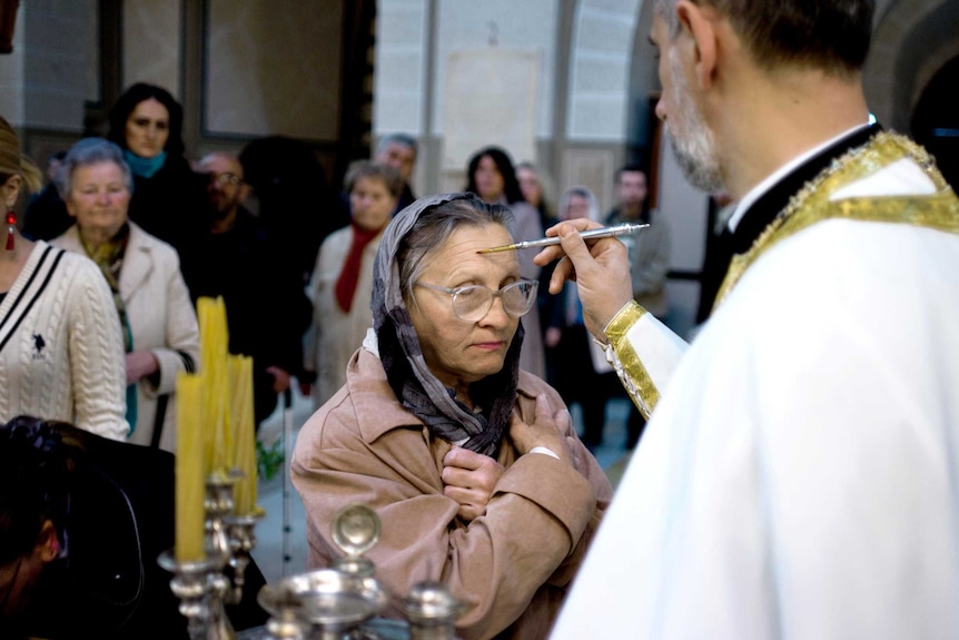 A Serb woman is blessed during Orthodox Easter in Sarajevo.