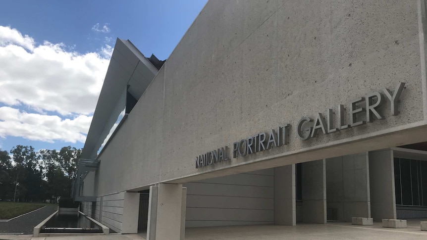 A metal sign reading 'NATIONAL PORTRAIT GALLERY' on the front of a cement building.