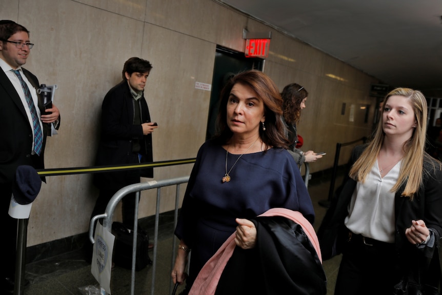 Annabella Sciorra walks past a line of people outside New York Criminal Court