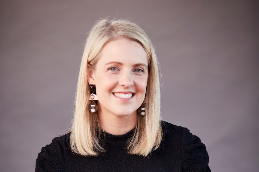 A professional portrait of a woman smiling.