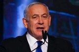 Israeli Prime Minister Benjamin Netanyahu points his fingers as he speaks at his party headquarters after the elections.