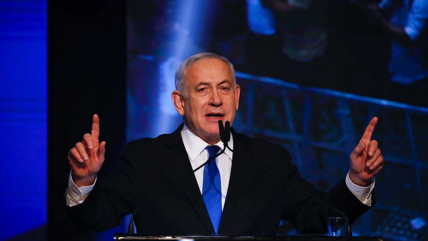 Israeli Prime Minister Benjamin Netanyahu points his fingers as he speaks at his party headquarters after the elections.