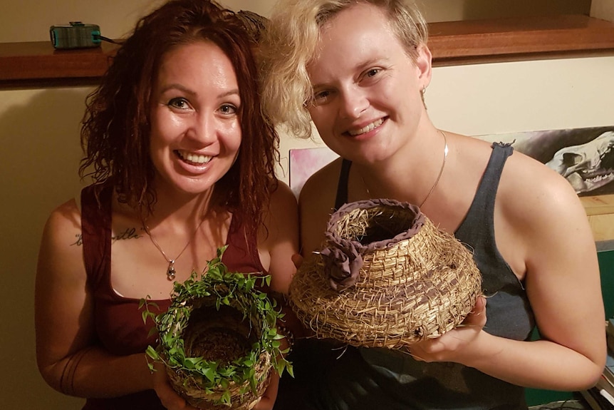 Monique Rossouw and Sara Walker hold two baskets made from natural materials